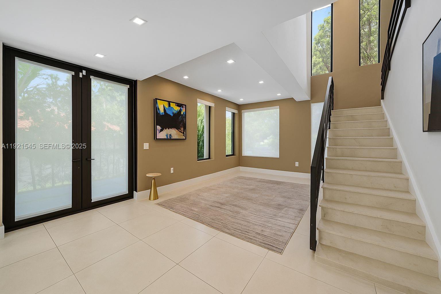 4740 Alton Road Miami Beach, FL 33140 - Photo 10 of 34 a view of a hallway with wooden floor and staircase