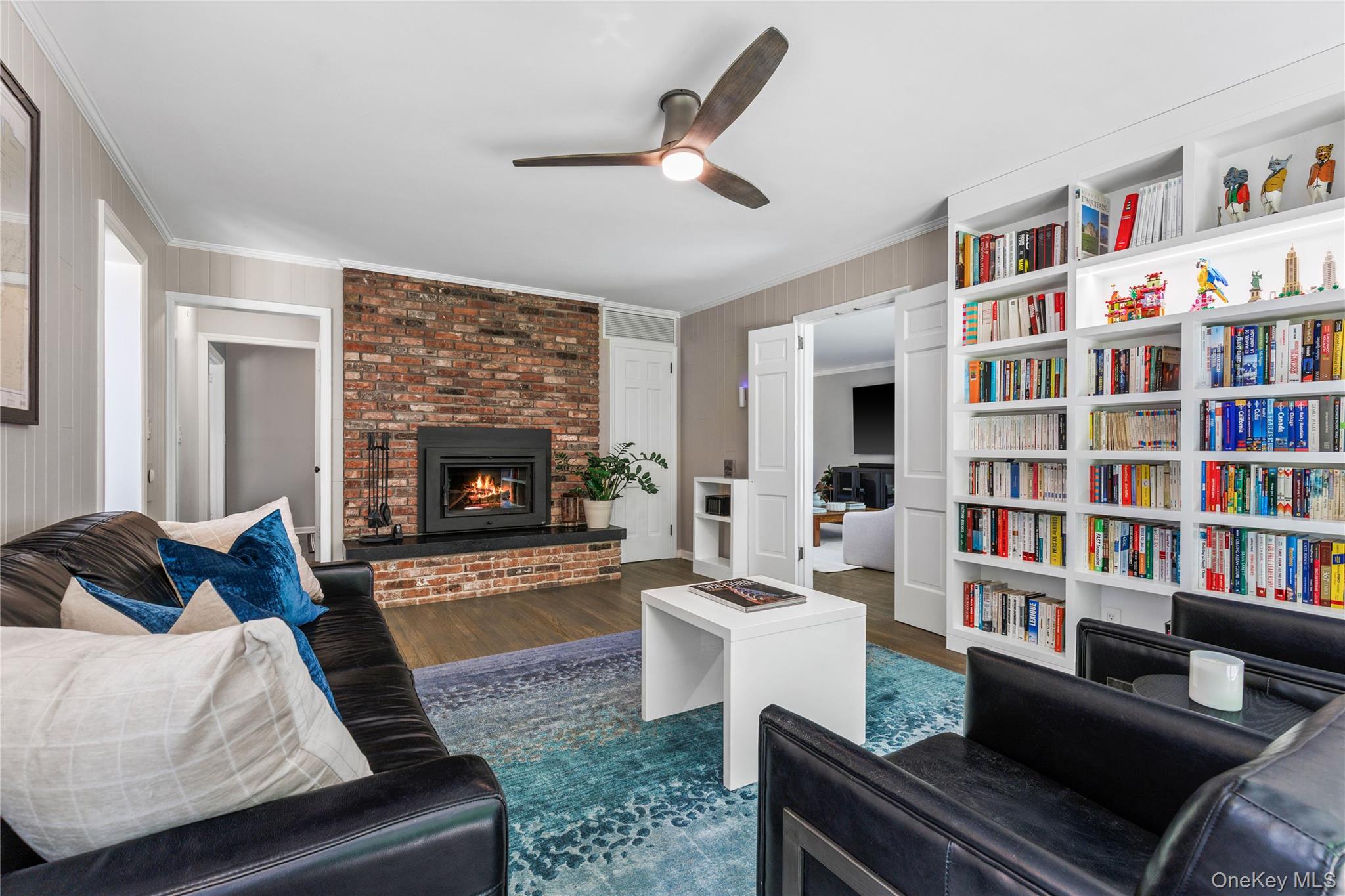 19 John Jay Place Rye, NY 10580 - Photo 20 of 45 A wall of purpose built bookshelves create an ideal space for reading or playing board games by the fire.