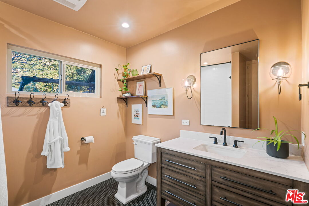 2304 Pickens Canyon Road La Crescenta, CA 91214 - Photo 15 of 37 a bathroom with a granite countertop toilet sink and mirror