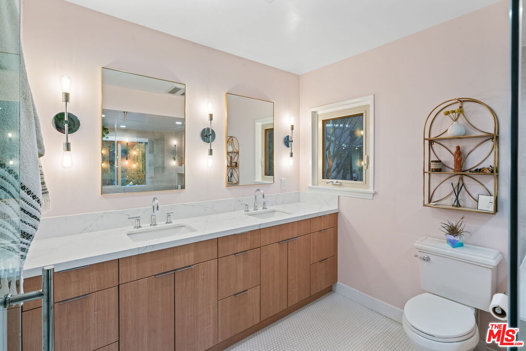 2304 Pickens Canyon Road La Crescenta, CA 91214 - Photo 20 of 37 a bathroom with a double vanity sink toilet and a mirror