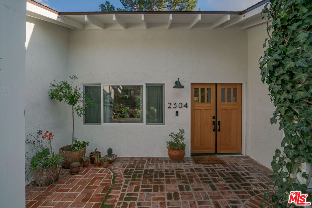 2304 Pickens Canyon Road La Crescenta, CA 91214 - Photo 2 of 37 a potted plant sitting in front of a house