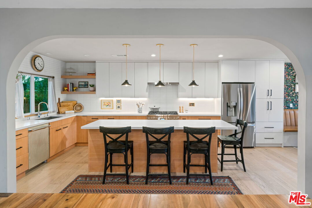 2304 Pickens Canyon Road La Crescenta, CA 91214 - Photo 7 of 37 a kitchen with stainless steel appliances granite countertop a dining table chairs refrigerator and sink