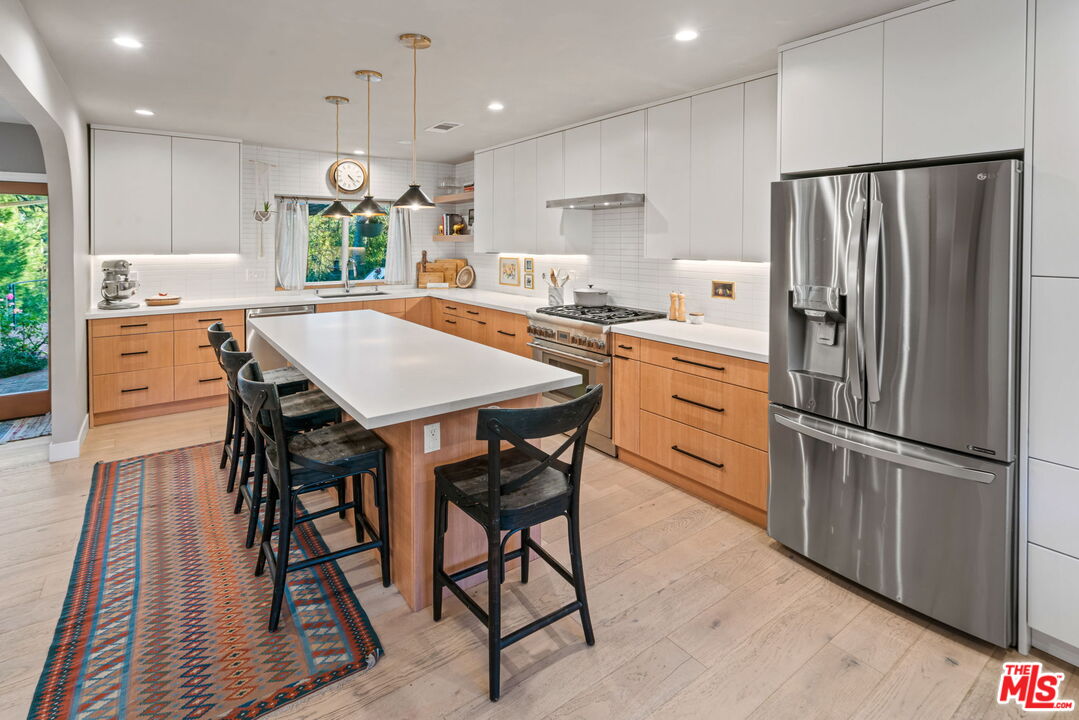2304 Pickens Canyon Road La Crescenta, CA 91214 - Photo 8 of 37 a kitchen with stainless steel appliances granite countertop a refrigerator a sink dishwasher a stove a refrigerator and white cabinets with wooden floor