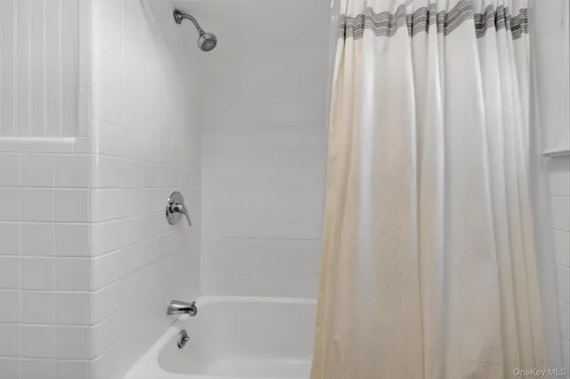 a bathroom with a shower curtain and a bathtub