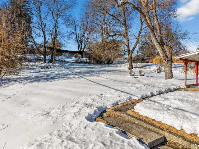 a view of a yard with snow on the road