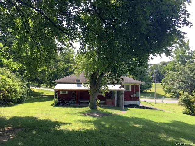 a view of a house with backyard sitting area and garden