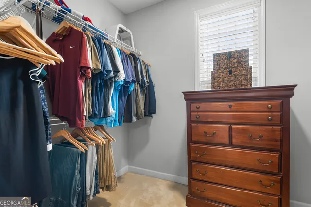 a living room with furniture kitchen view and a chandelier