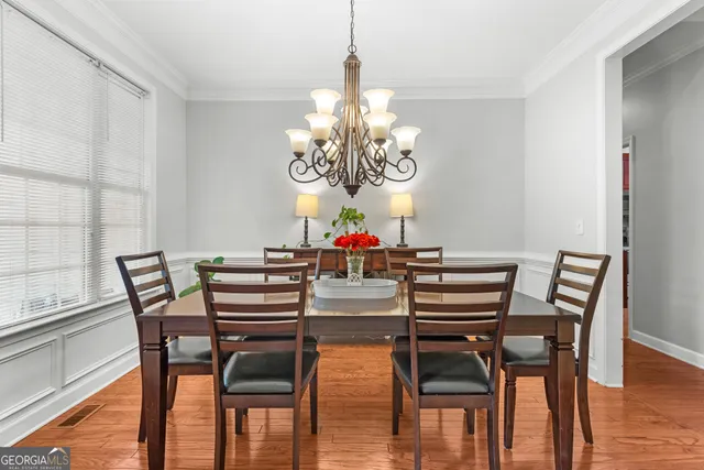 a view of a dining room with furniture and a chandelier