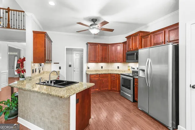 a kitchen with stainless steel appliances granite countertop a sink stove and cabinets
