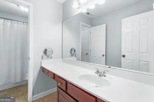 an empty room with chandelier fan