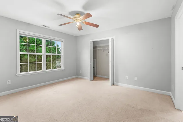a spacious bedroom with a bed a couch and a window
