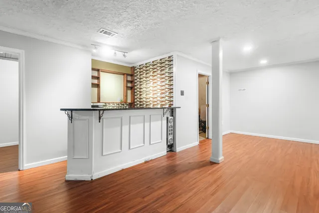a bathroom with a granite countertop shower and a sink