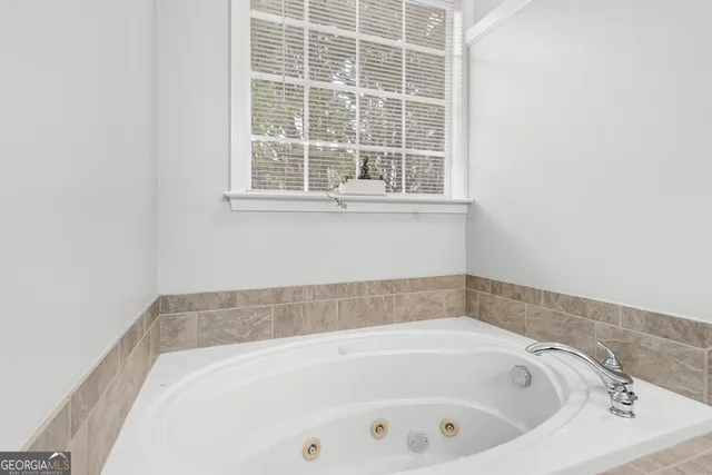 a bath tub sitting next to a window