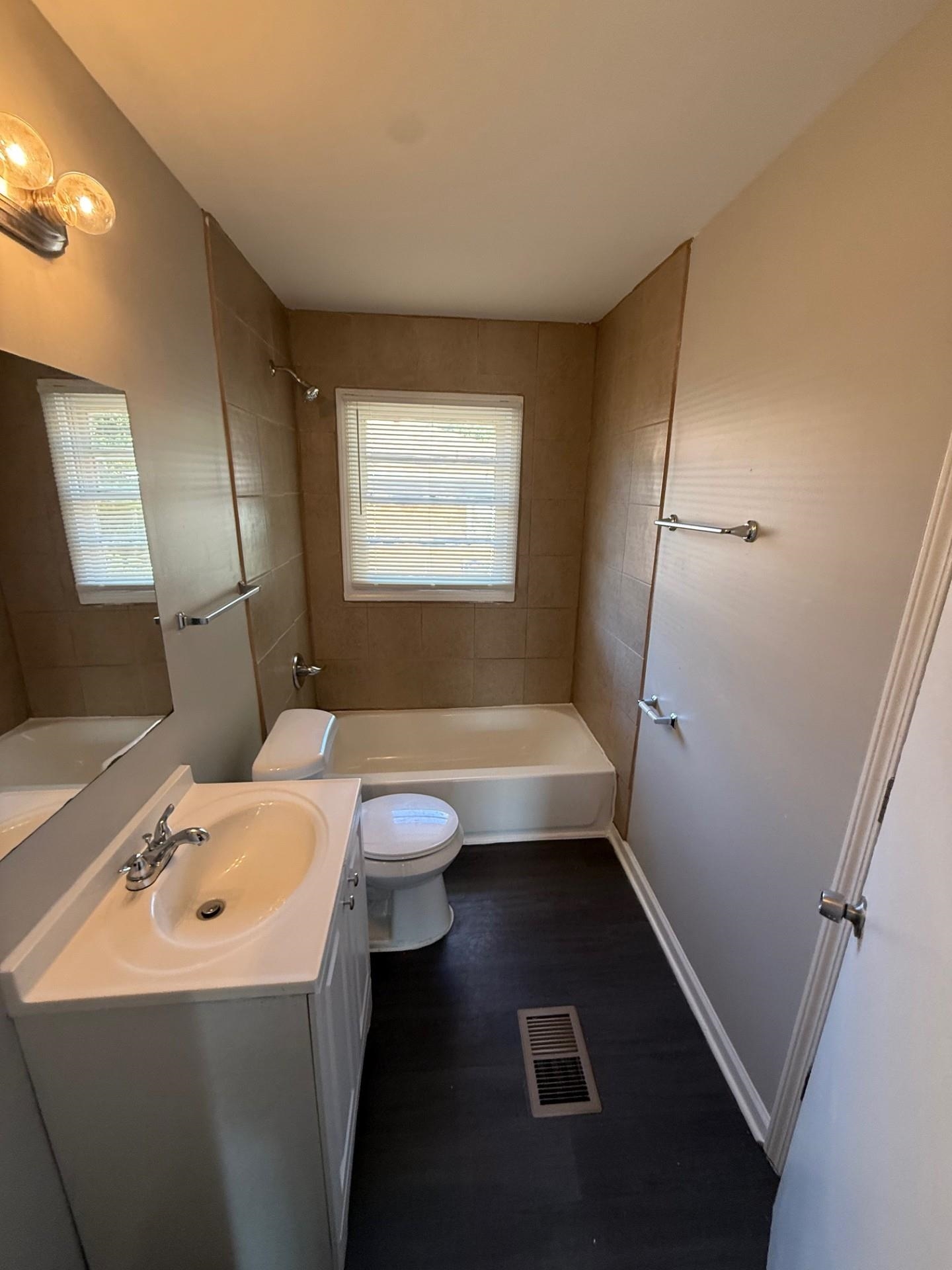 1560 Cane Road Memphis, TN 38106 - Photo 12 of 15 a bathroom with a sink a toilet and shower