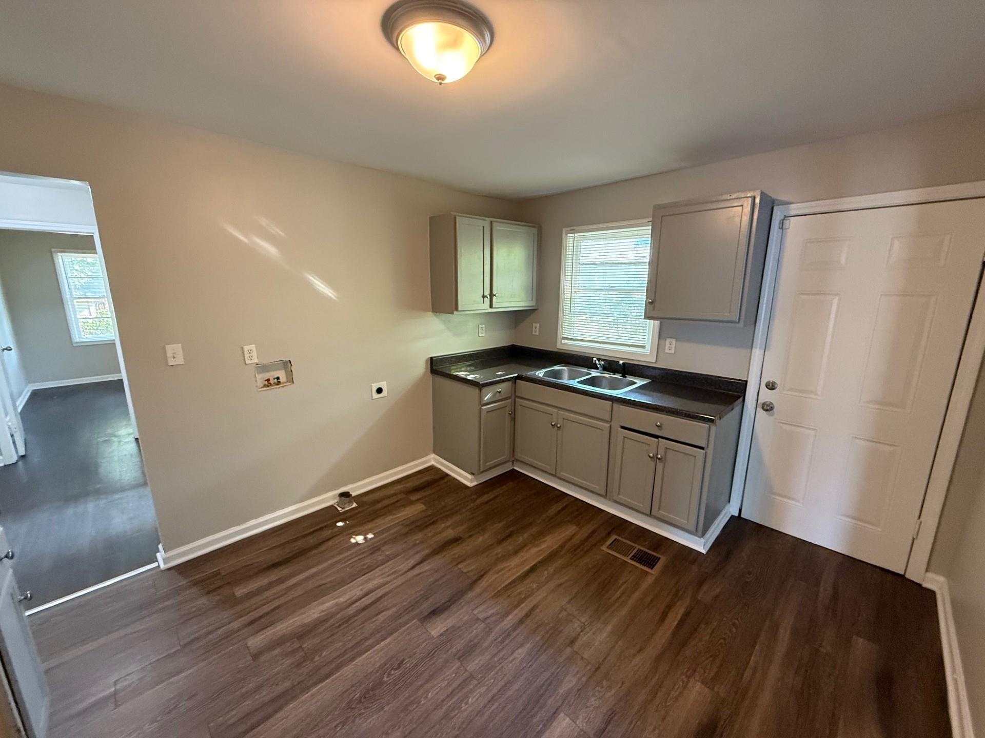1560 Cane Road Memphis, TN 38106 - Photo 14 of 15 a kitchen with granite countertop a stove and a refrigerator