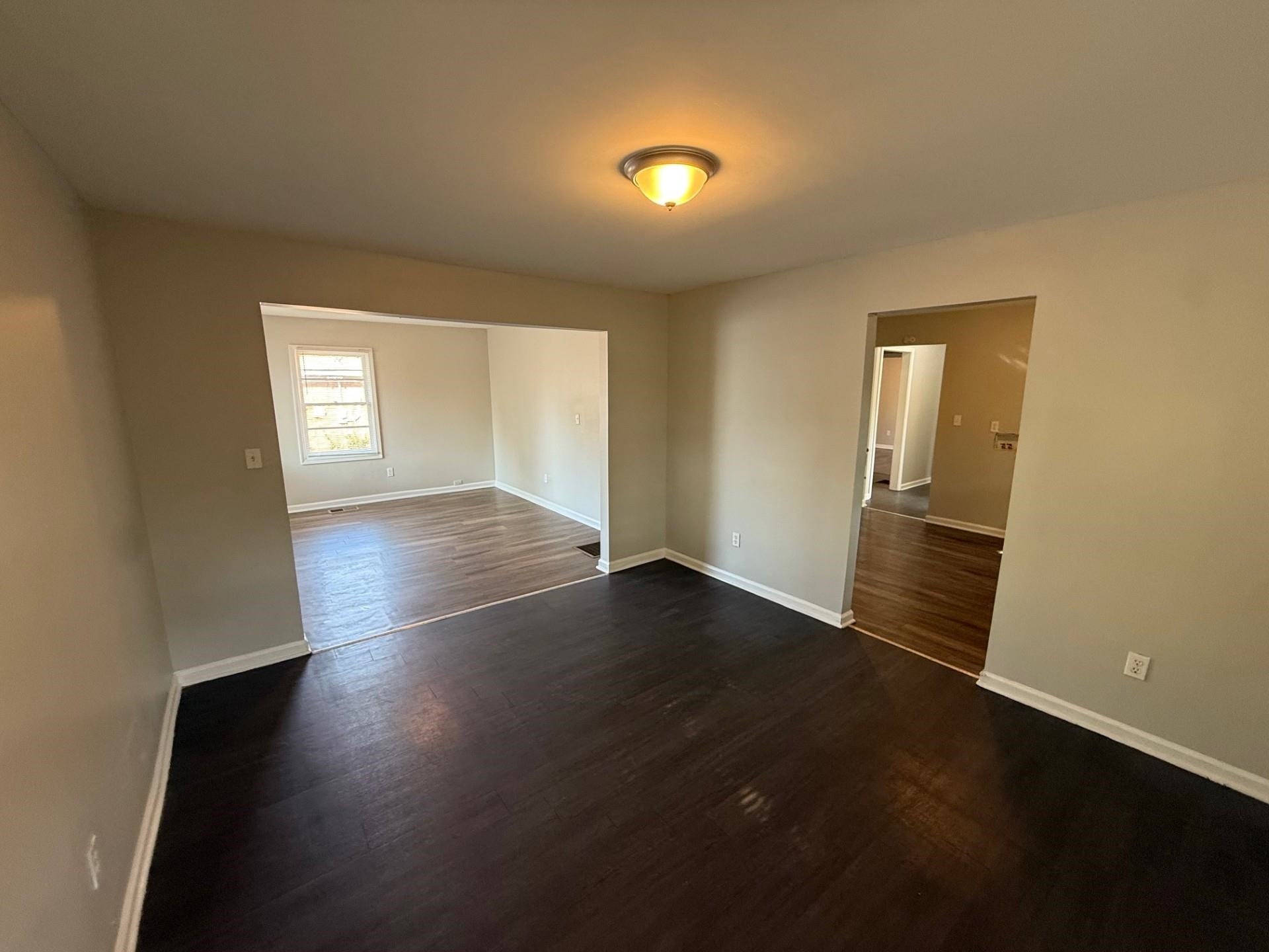 1560 Cane Road Memphis, TN 38106 - Photo 15 of 15 an empty room with wooden floor and windows