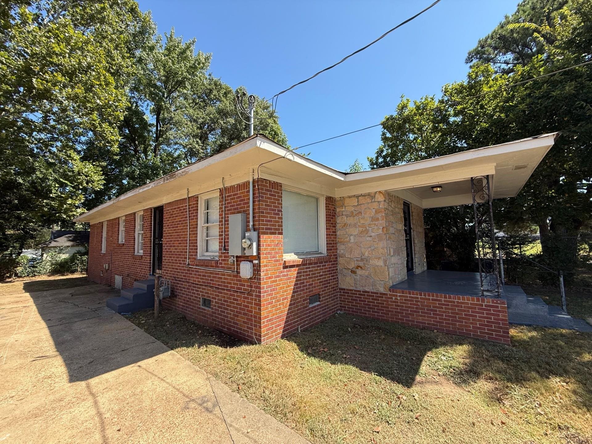 1560 Cane Road Memphis, TN 38106 - Photo 3 of 15 a front view of a house with a yard