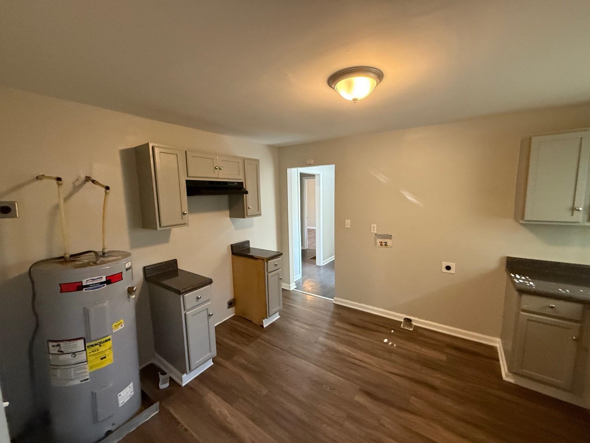 1560 Cane Road Memphis, TN 38106 - Photo 6 of 15 a view of a kitchen with fridge and wooden floor