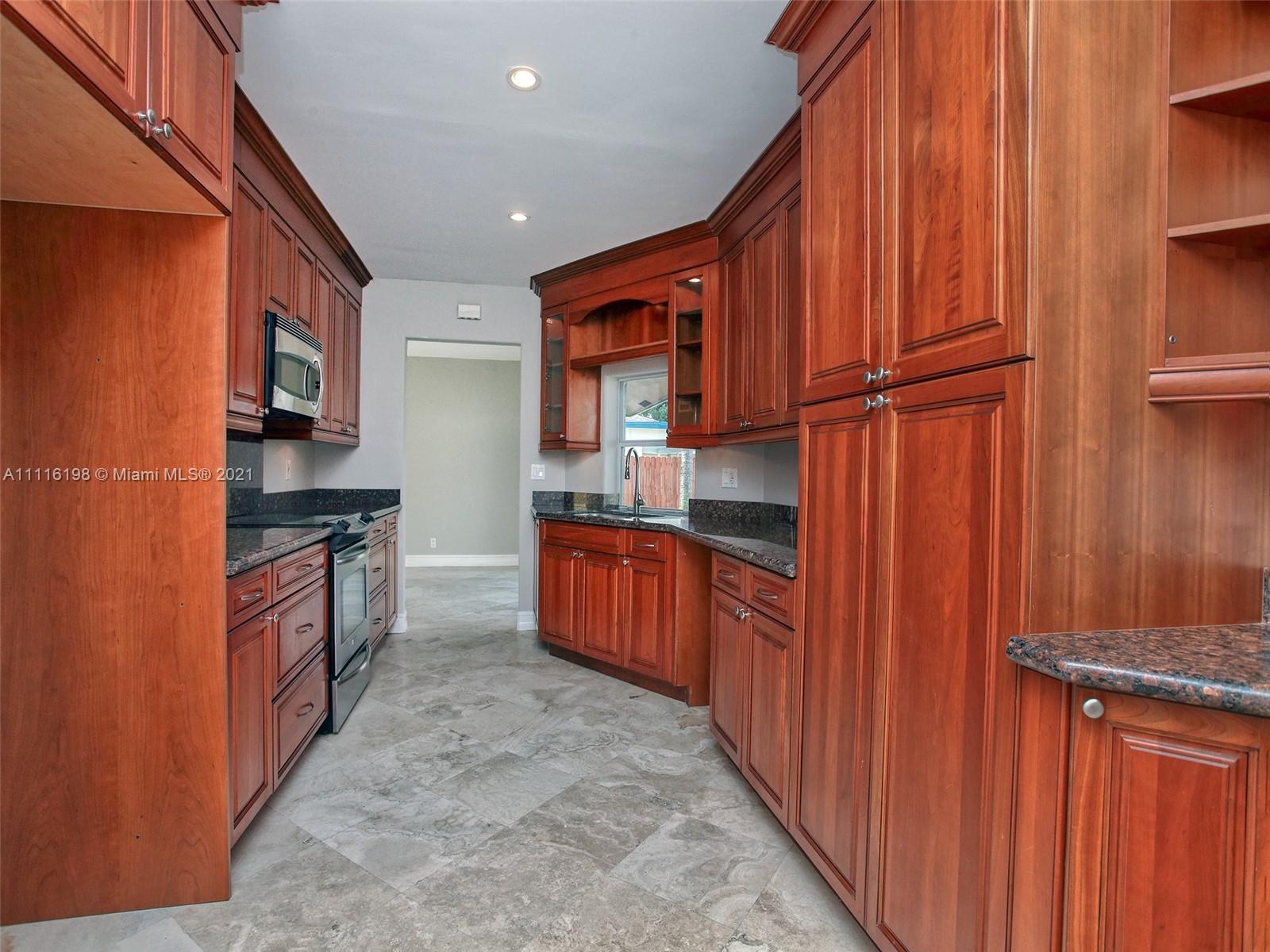 49 Southwest 12th Avenue Boca Raton, FL 33486 - Photo 11 of 30 a kitchen with stainless steel appliances granite countertop a refrigerator and a stove