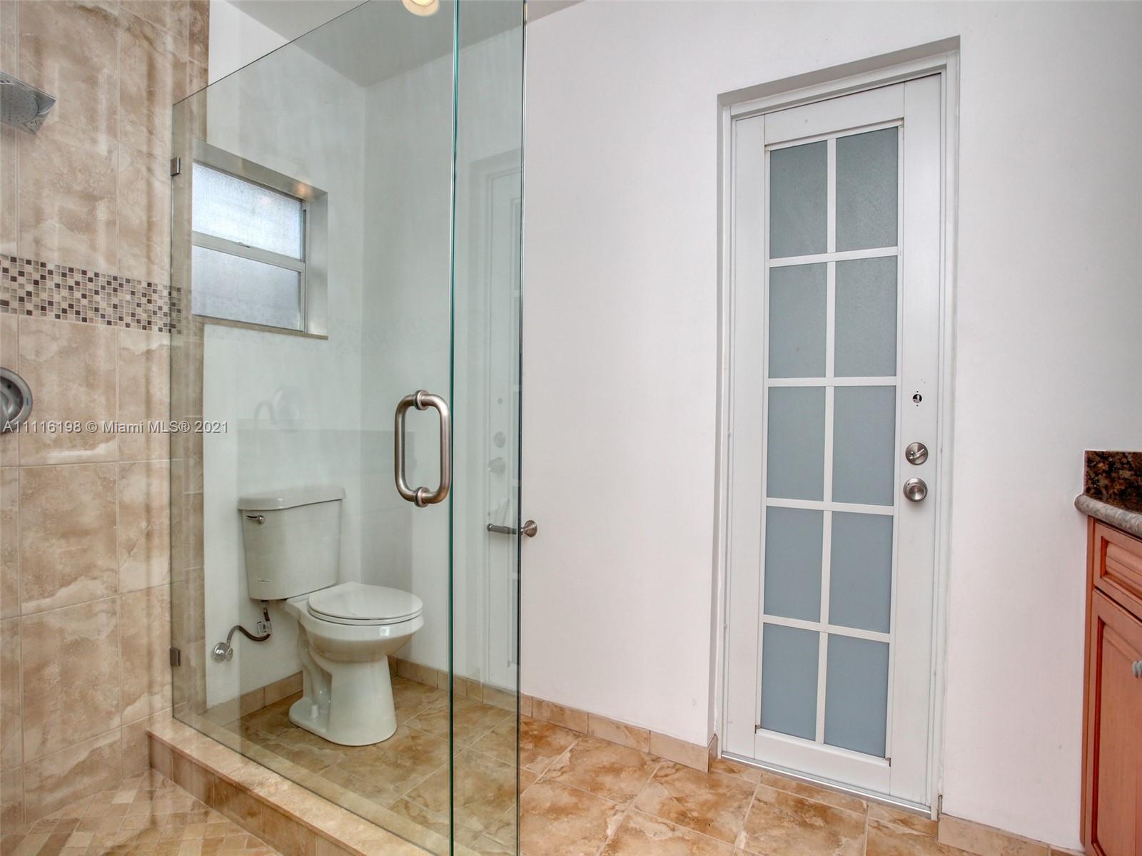 49 Southwest 12th Avenue Boca Raton, FL 33486 - Photo 15 of 30 a bathroom with a toilet and a shower