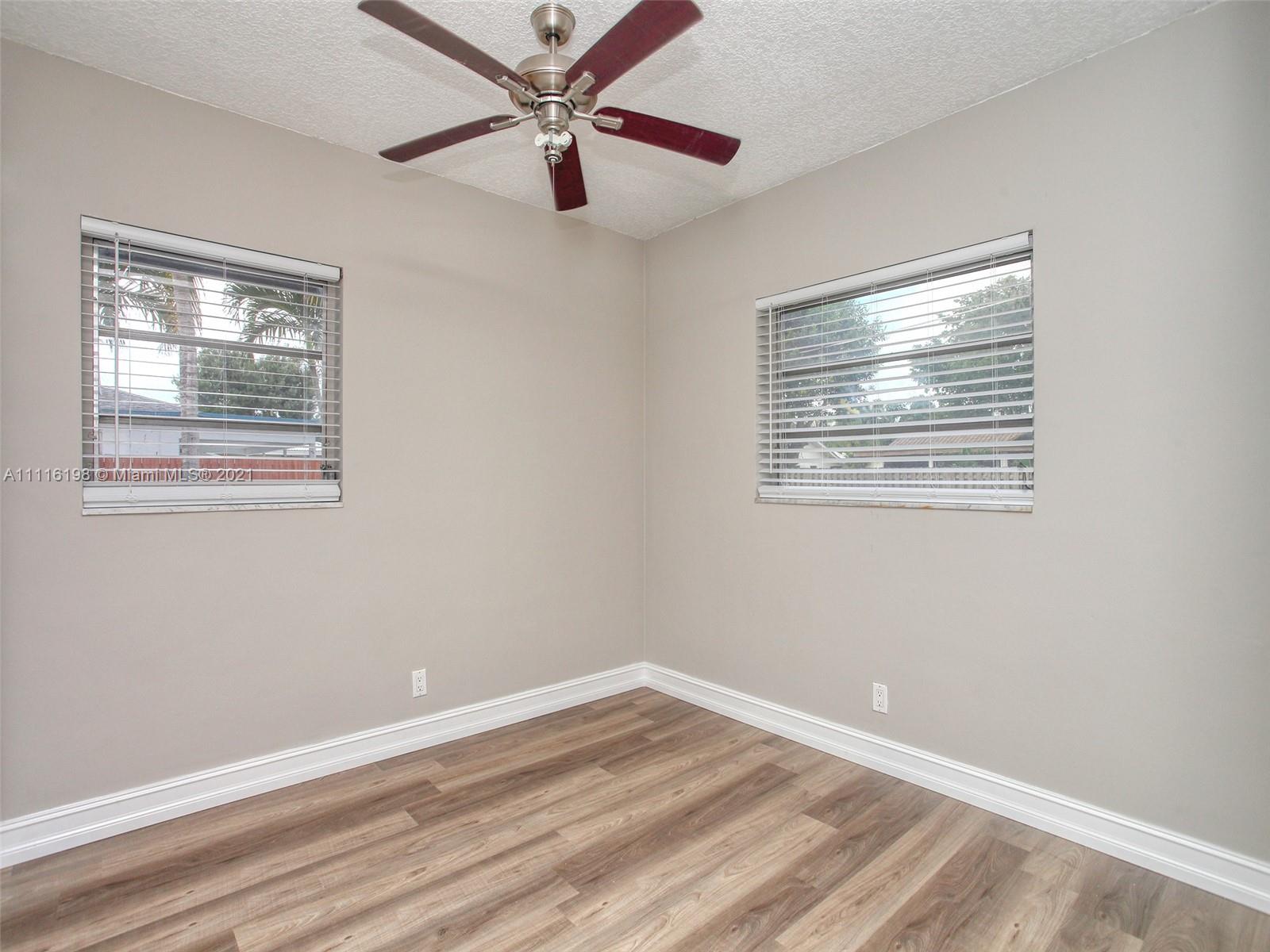 49 Southwest 12th Avenue Boca Raton, FL 33486 - Photo 20 of 30 a view of an empty room with wooden floor and a window