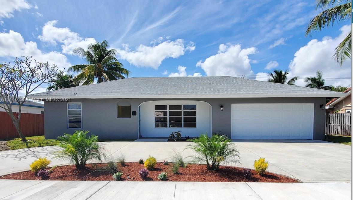 49 Southwest 12th Avenue Boca Raton, FL 33486 - Photo 2 of 30 a potted plant sitting in front of a house
