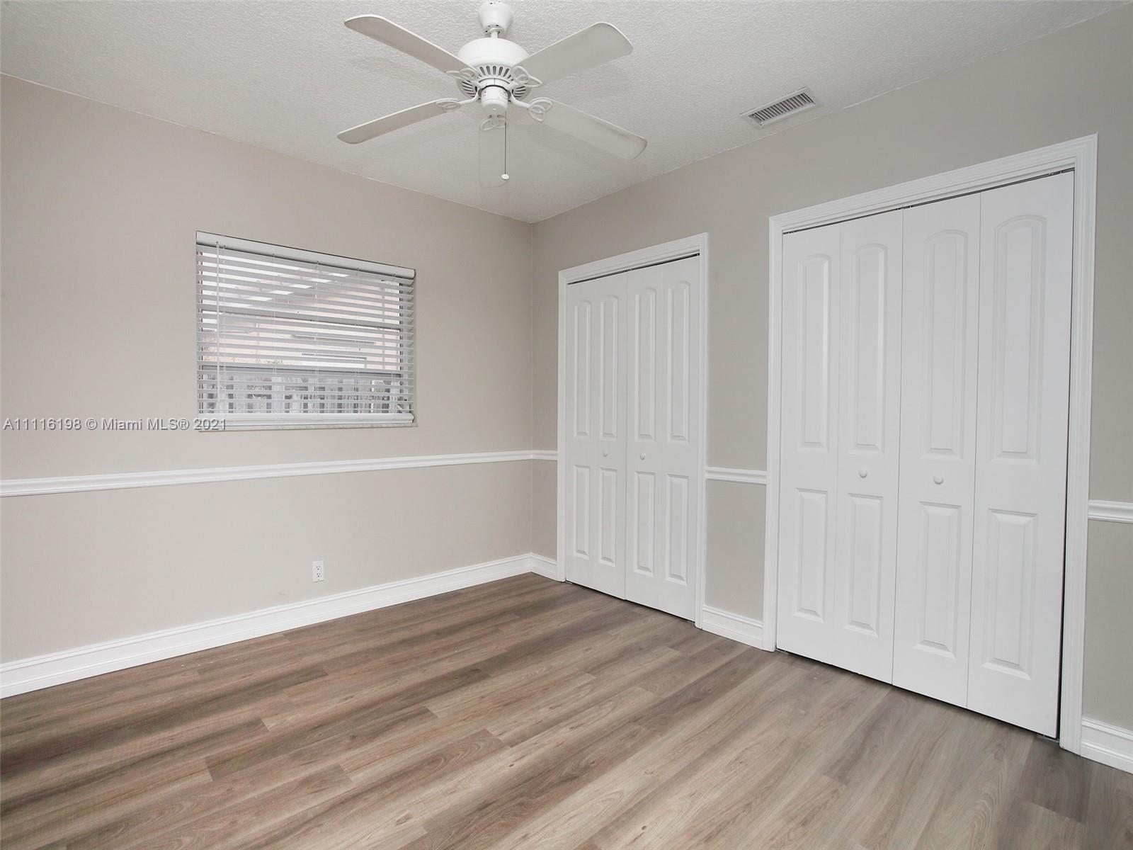 49 Southwest 12th Avenue Boca Raton, FL 33486 - Photo 22 of 30 wooden floor in an empty room with a window