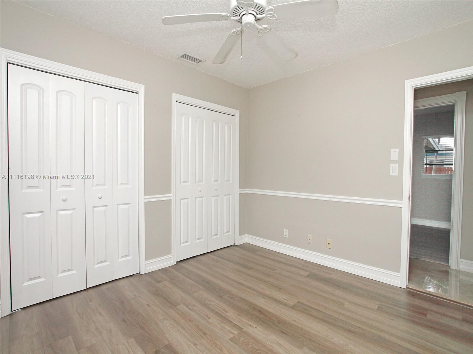 49 Southwest 12th Avenue Boca Raton, FL 33486 - Photo 23 of 30 an empty room with wooden floor closet and windows