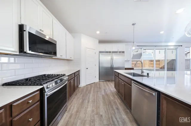 a kitchen with a stove and a wooden floor
