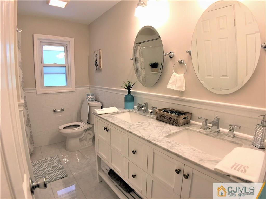 31 Meredith Road Piscataway, NJ 08854 - Photo 14 of 23 a bathroom with a granite countertop toilet a sink and a mirror