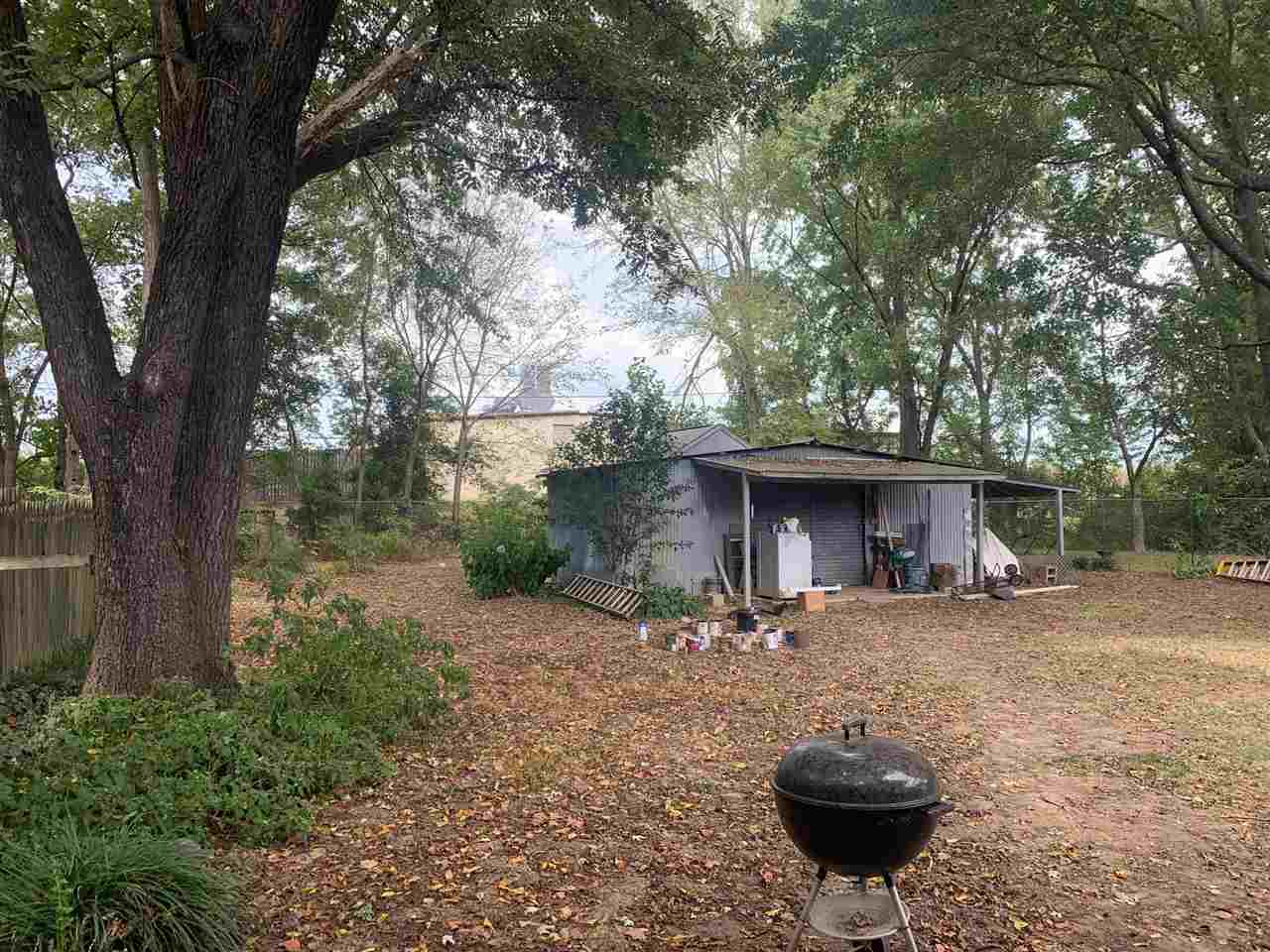 4588 Talley Road Millington, TN 38053 - Photo 16 of 17 a view of a backyard with table and chairs and a large tree