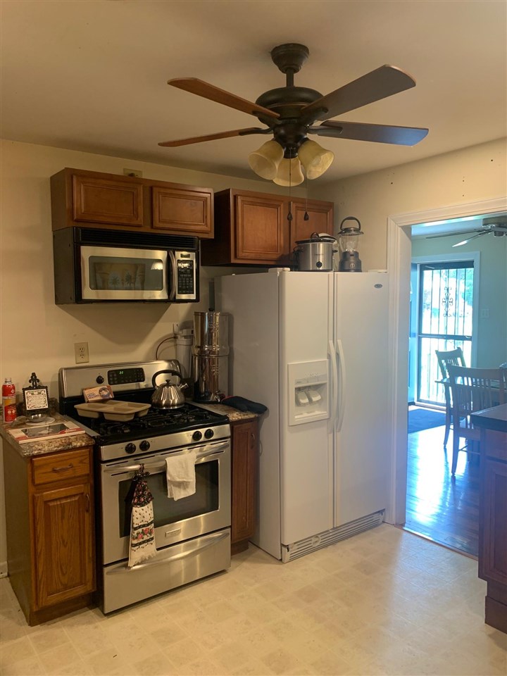 4588 Talley Road Millington, TN 38053 - Photo 5 of 17 a kitchen with stainless steel appliances granite countertop a stove and a refrigerator