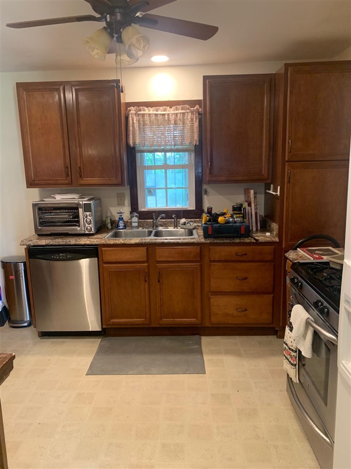 4588 Talley Road Millington, TN 38053 - Photo 6 of 17 a kitchen with stainless steel appliances granite countertop a stove a sink dishwasher and a refrigerator