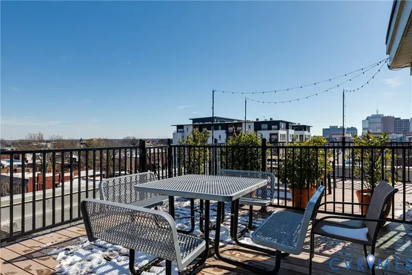 a view of a chairs and table in the roof deck