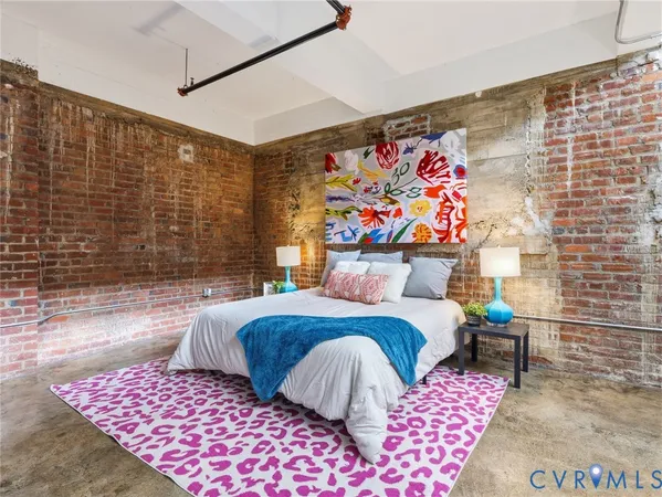 a bedroom with a bed and a painting on the wall