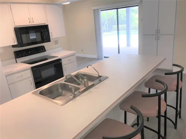 a kitchen with a sink and a stove top oven