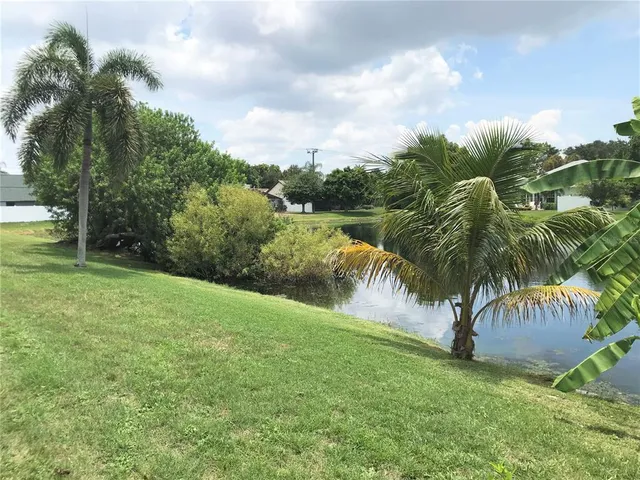 a backyard of a house with plants and outdoor seating