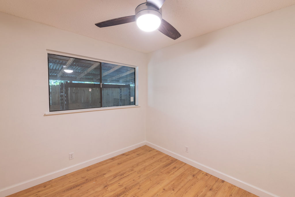5310 Presidio Road Austin, TX 78745 - Photo 21 of 34 Laminate flooring and a ceiling fan create a comfortable atmosphere in this inviting room.