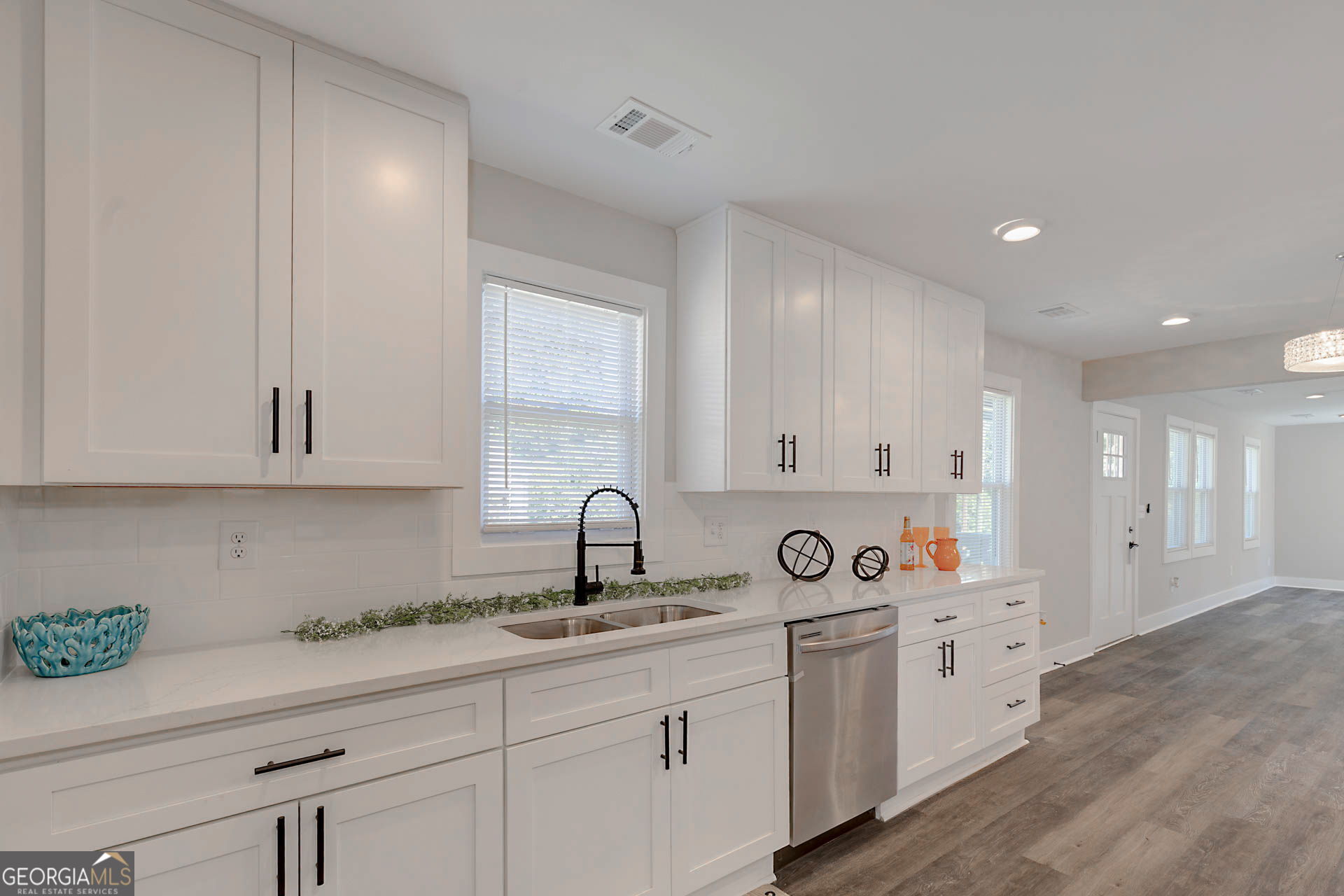 326 Mobley Street Hamilton, GA 31811 - Photo 13 of 27 a kitchen with white cabinets a sink and dishwasher