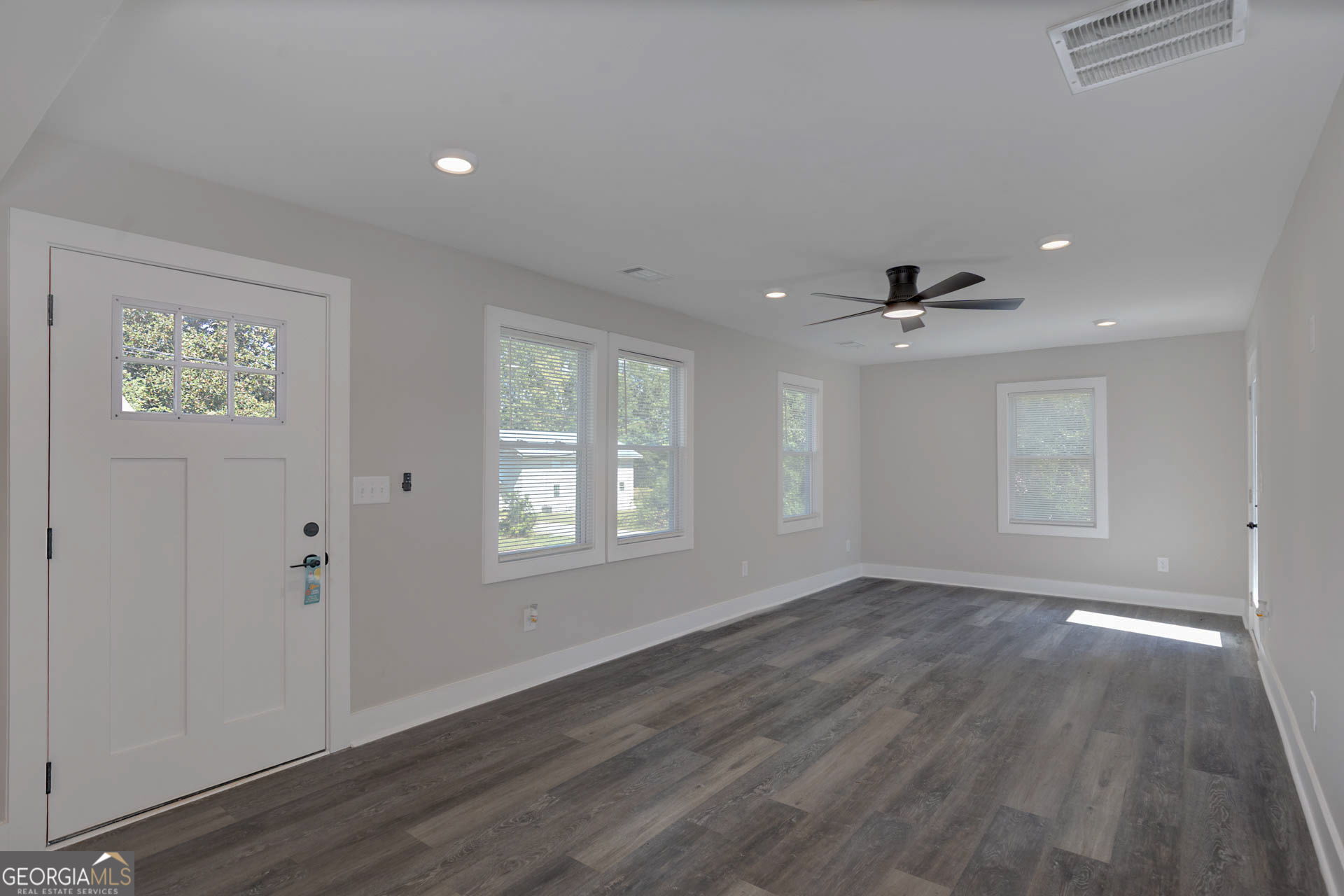 326 Mobley Street Hamilton, GA 31811 - Photo 18 of 27 wooden floor in an empty room with a window