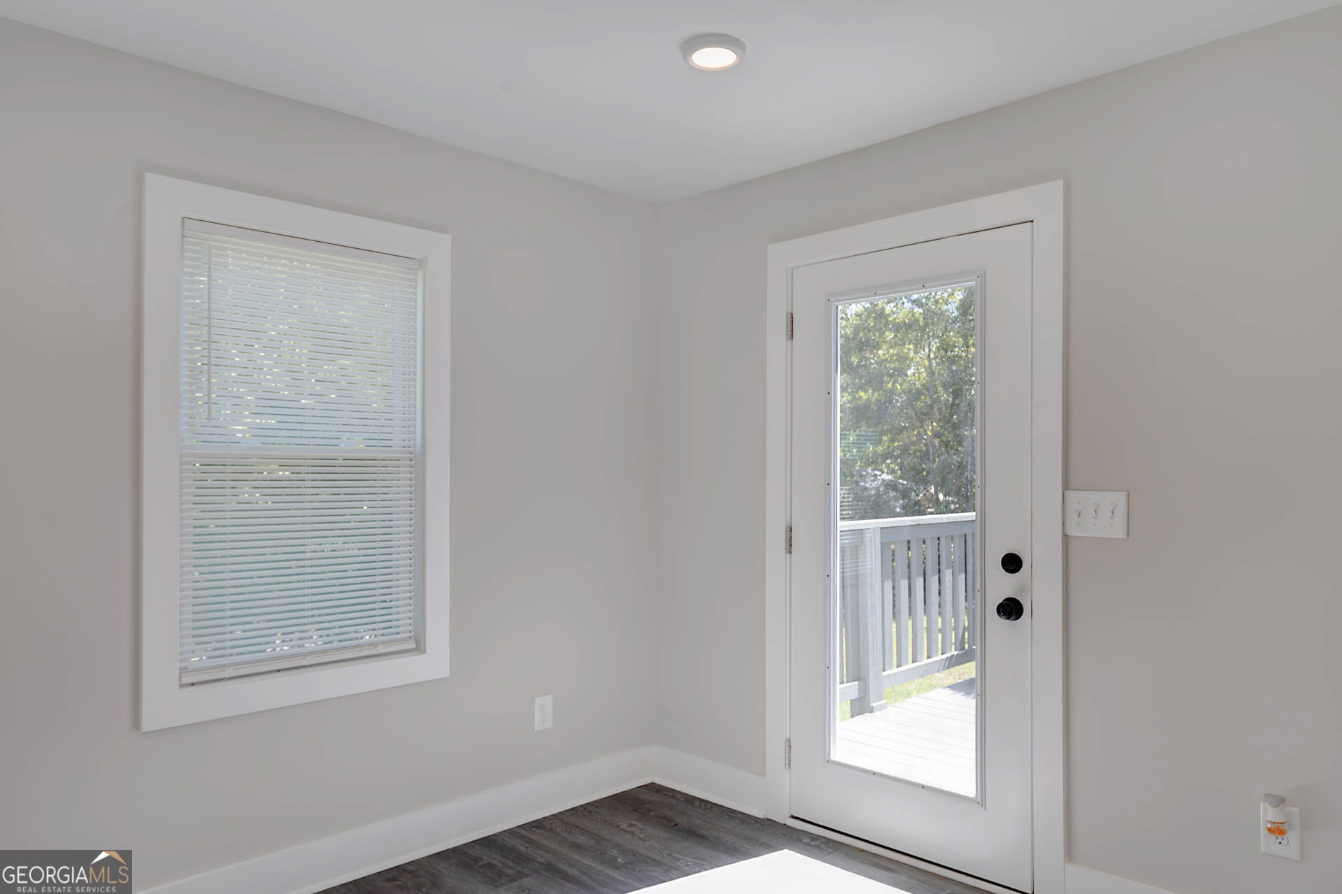 326 Mobley Street Hamilton, GA 31811 - Photo 19 of 27 an empty room with wooden floor and a window