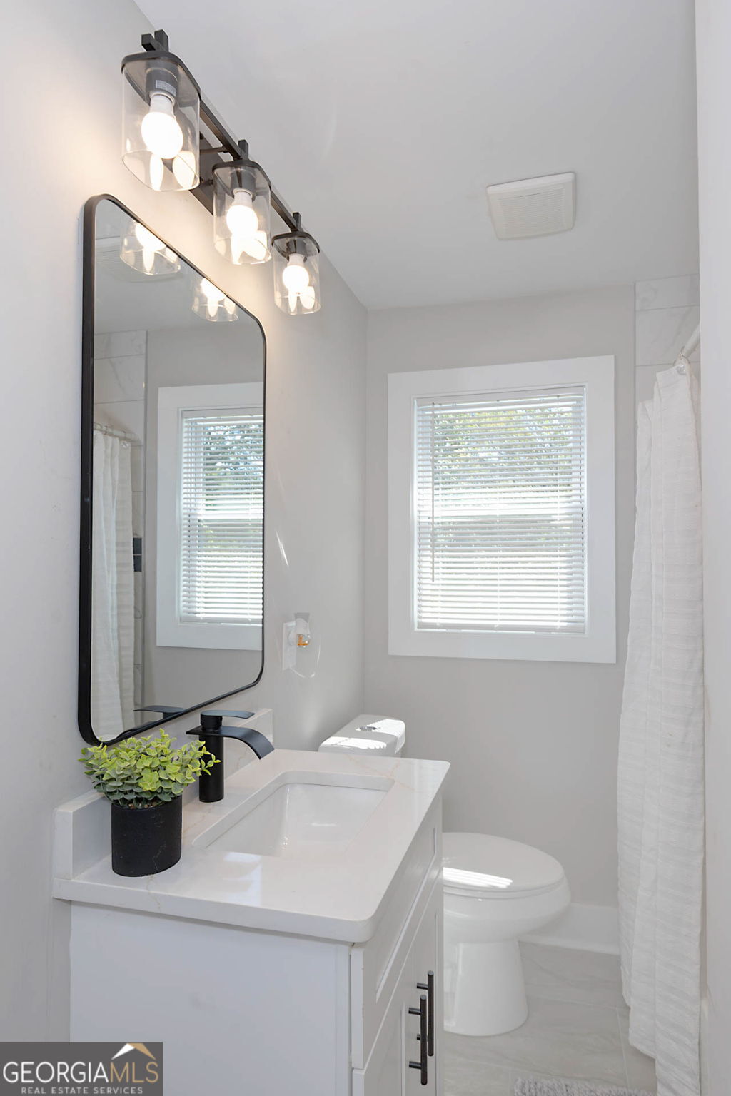 326 Mobley Street Hamilton, GA 31811 - Photo 23 of 27 a bathroom with a sink a mirror and a toilet