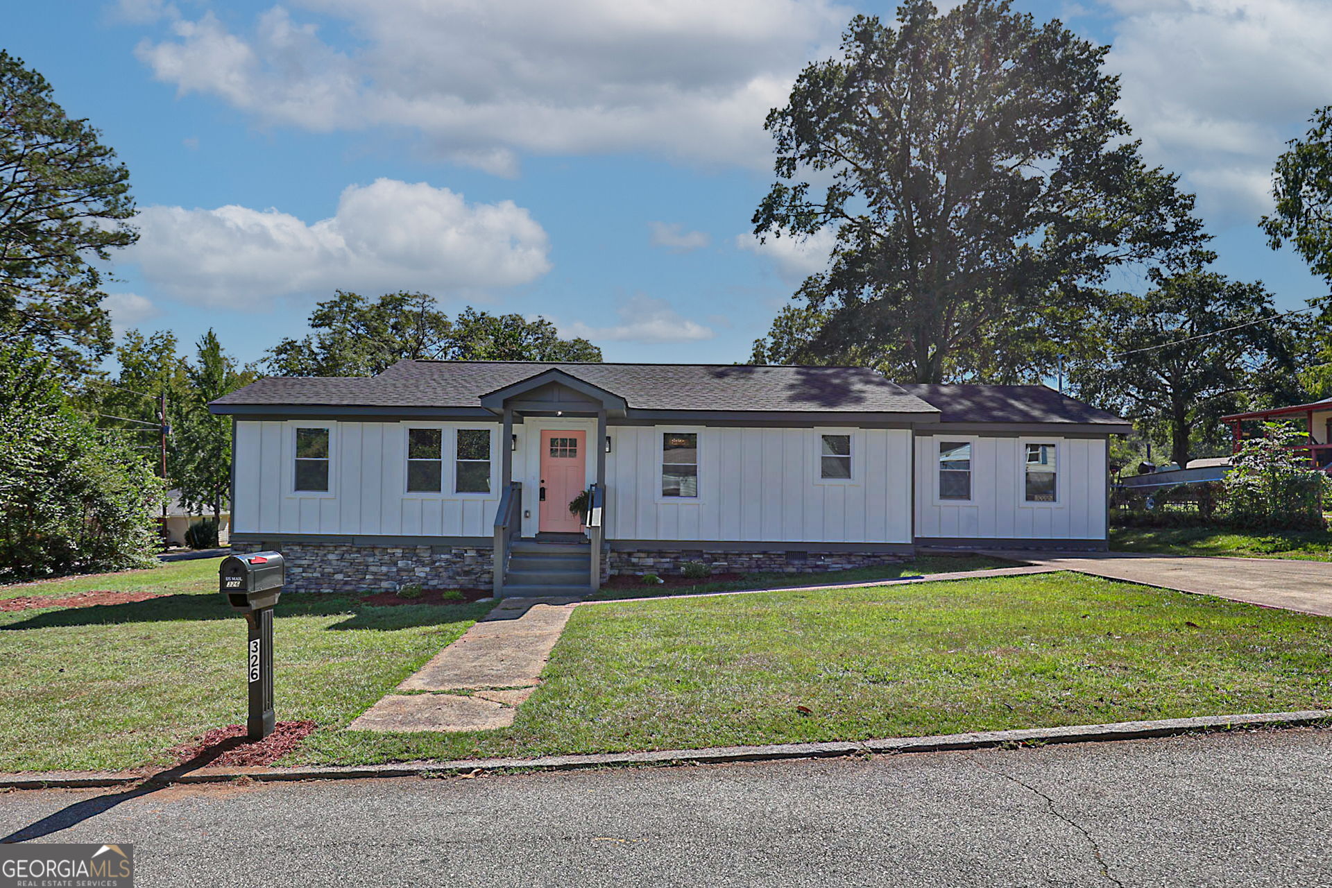 326 Mobley Street Hamilton, GA 31811 - Photo 27 of 27 a front view of a house with a yard and garage