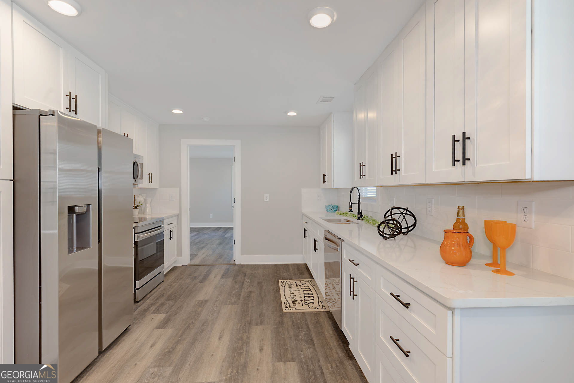 326 Mobley Street Hamilton, GA 31811 - Photo 8 of 27 a kitchen with stainless steel appliances a refrigerator sink and cabinets