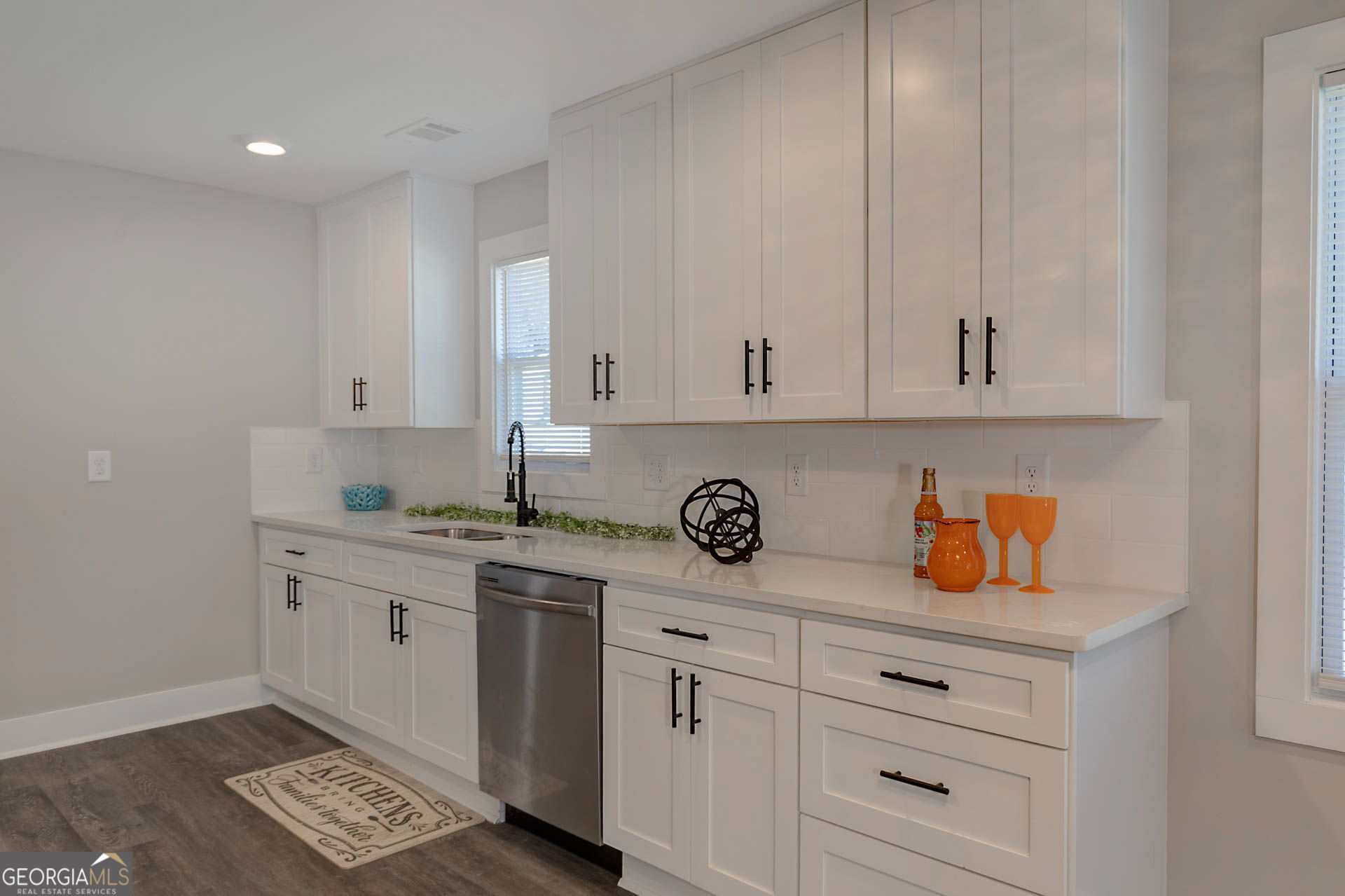 326 Mobley Street Hamilton, GA 31811 - Photo 10 of 27 a kitchen with white cabinets and sink