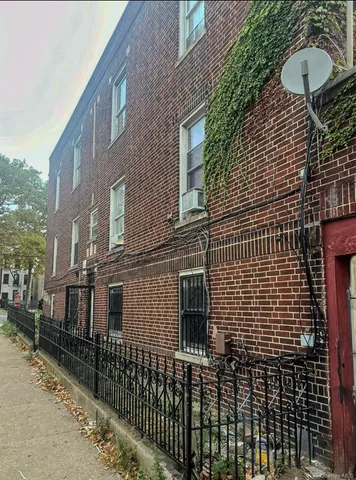 a view of a brick house with many windows