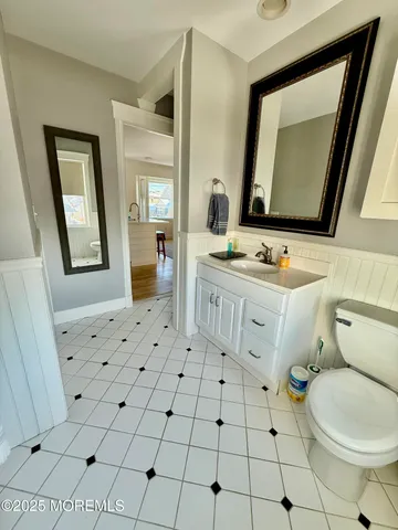 a bathroom with a sink mirror vanity and toilet