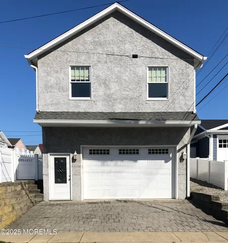 a front view of a house with garage