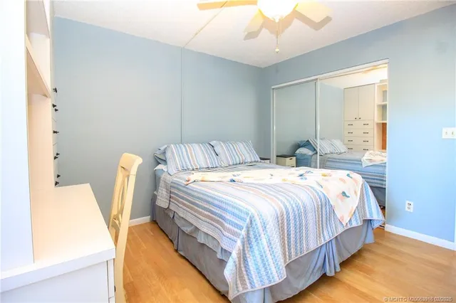 a bedroom with bed and wooden floor