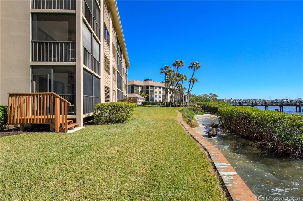 4490 Northeast Sandpebble Trace, Unit 105 Stuart, FL 34996 - Photo 23 of 38 a view of a house with backyard and sitting area